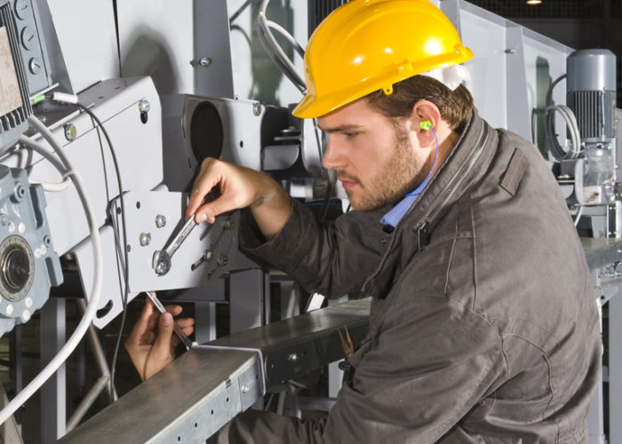 A male maintenance engineer at work on an industrial appliance